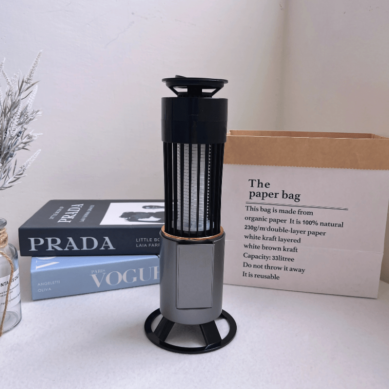 Stylish mosquito zapper lamp with modern base and USB-C charging, displayed on a desk with decor. Silent, portable, and safe for indoor use.