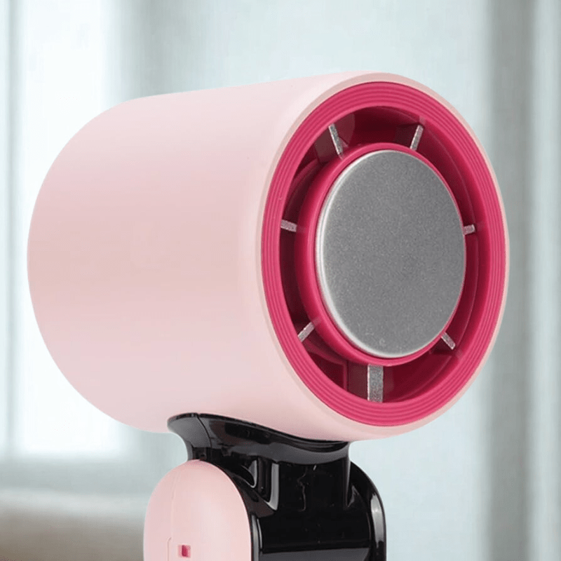 Close-up of the Techynook handheld bladeless fan in pink, showing the safety ring and modern turbine-style air outlet