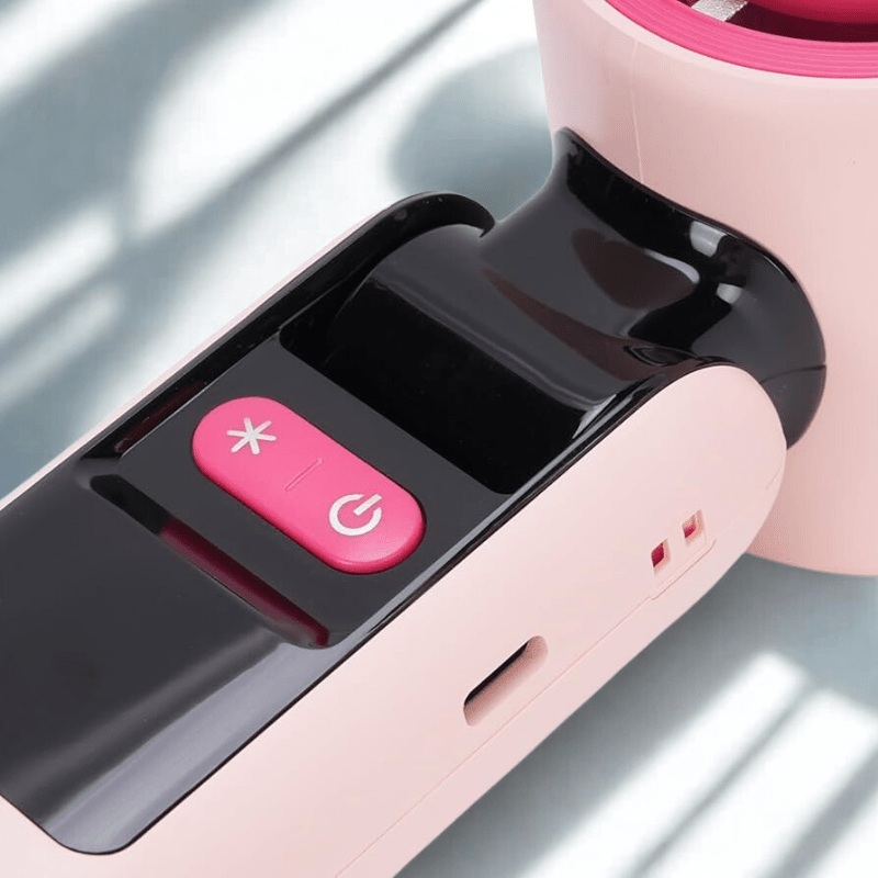 Detail of the Techynook pink portable fan showing power and cooling buttons with USB-C charging port