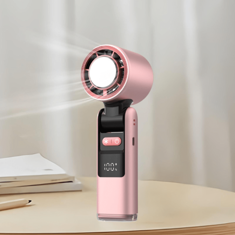 Techynook pink handheld fan in action on a desk, showing airflow and digital battery display