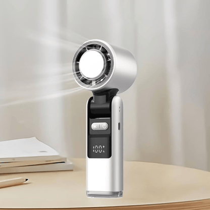 Techynook white handheld fan in use on a desk, showing airflow and battery level on LED screen
